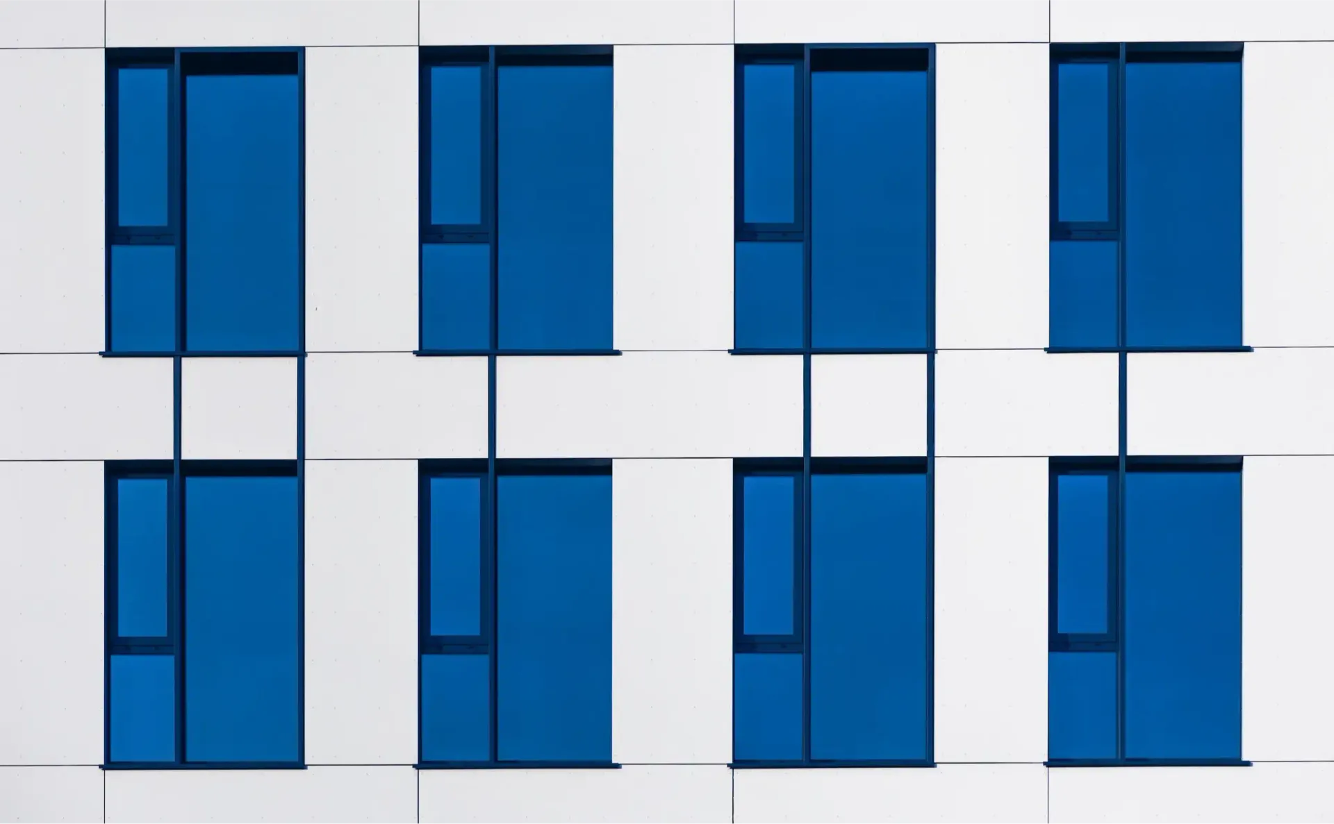 A white and blue building with blue windows