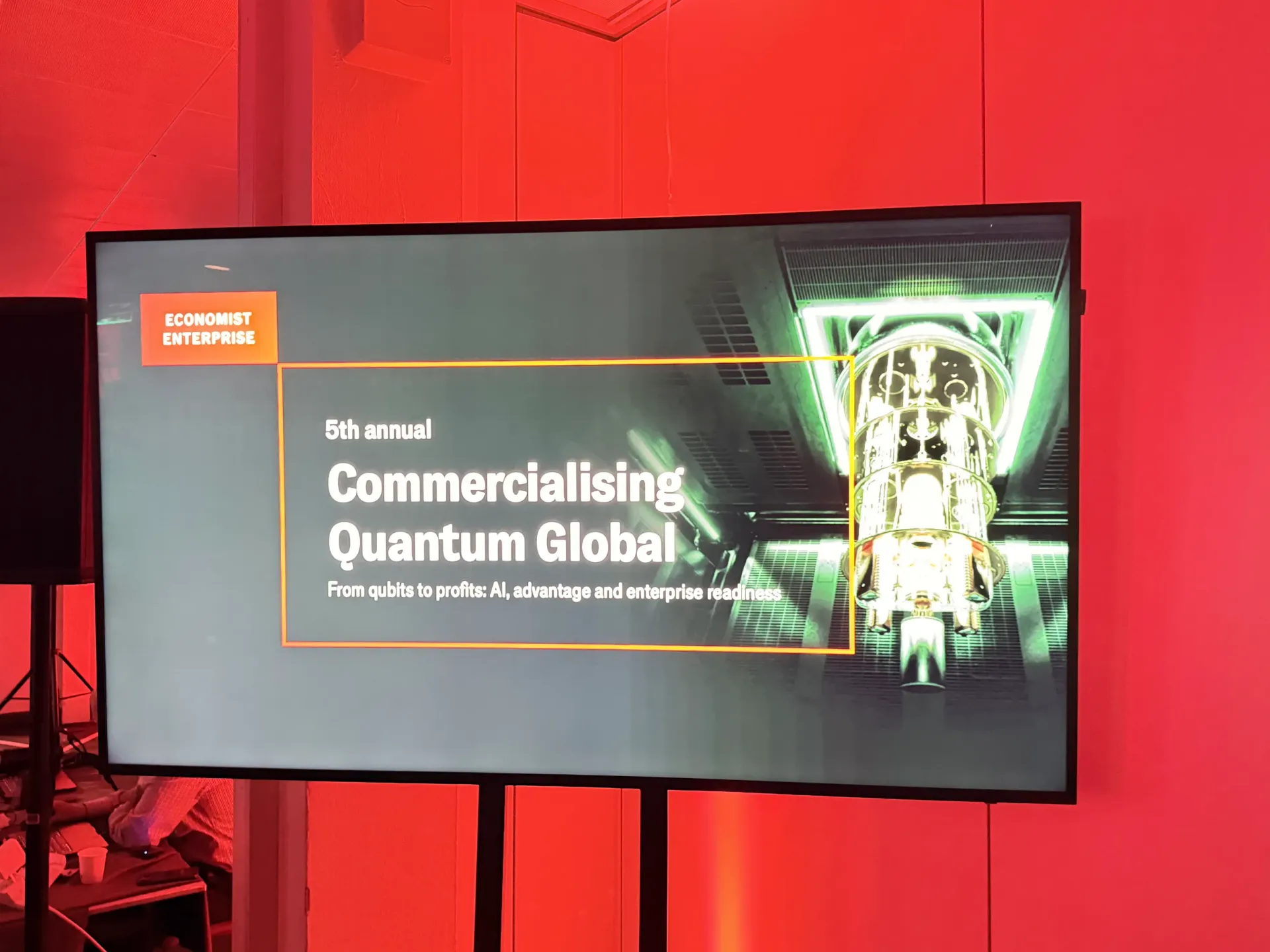 Stage view from the Economist Impact 5th Annual Commercialising Quantum Global 2026 summit in London — symbolising quantum technology's transition from physics research to enterprise-ready workflows